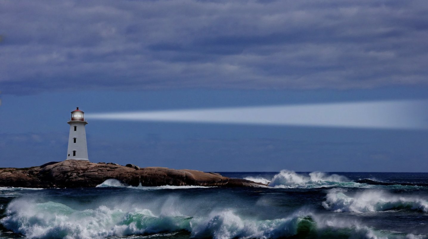 A lighthouse standing on a rocky coast above breaking waves